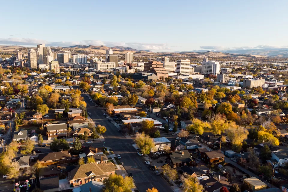 Aerial view of Reno, Nevada with homes in foreground and downtown buildings in background during autumn.
